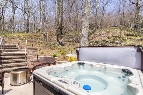 a jacuzzi tub on a patio with trees at Top Of The Hill in Seven Devils