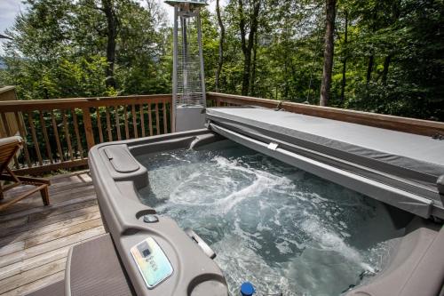 a hot tub on the deck of a house at Tree Top Lodge in Sugar Mountain