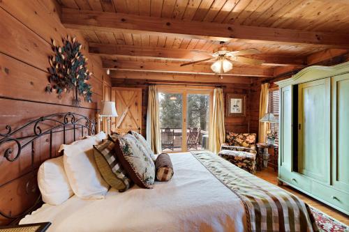 a bedroom with a bed and a ceiling fan at Whispering Pines in Blowing Rock