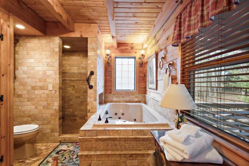 a large bathroom with a tub and a toilet at Whispering Pines in Blowing Rock