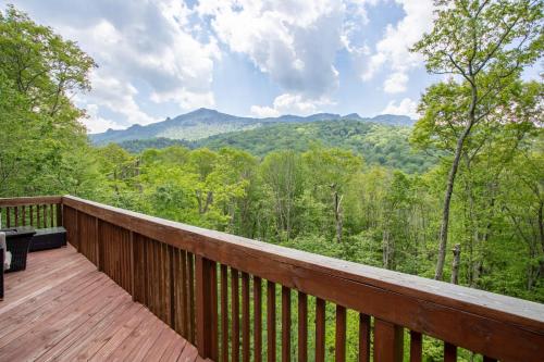 a wooden deck with a view of the mountains at Villa Costalotta in Sugar Mountain