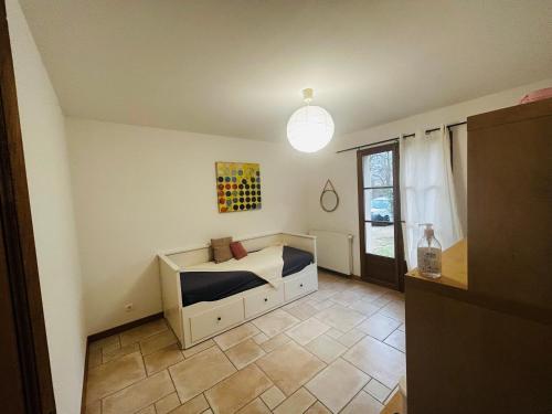 Habitación pequeña con cama y ventana en Chambre privée avec coin wc lave main privatif en Grez-sur-Loing