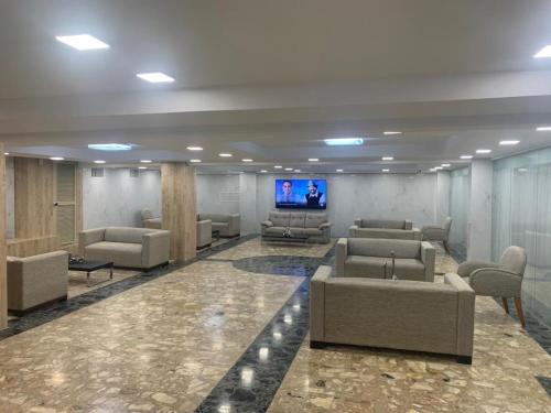 a lobby with couches and a flat screen tv at HOTEL PRINCESA PLAZA in Maracay