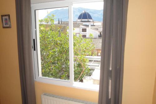 a window with a view of a city at Hostal Cristina in Denia
