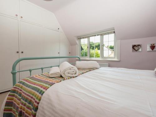 una camera da letto con un letto e asciugamani di Mast Cottage a Burley