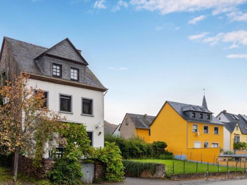 a group of houses with yellow and white at Serene Holiday Home in Nehren with a beautiful Garden in Nehren