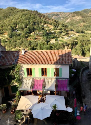 an overhead view of a building with umbrellas in front at Chambre d hôte La cool room in Antraigues