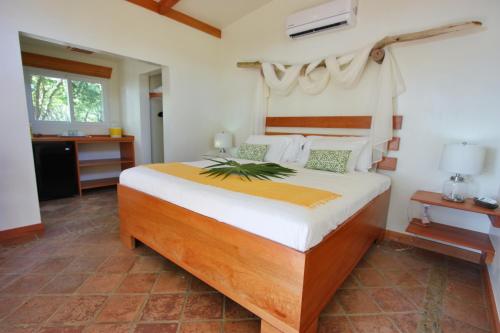 A bed or beds in a room at Coral Beach Village Resort