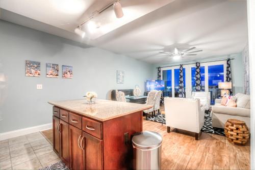 a kitchen and living room with a table and a couch at Laketown Wharf Resort 631 By Aneliya in Panama City Beach