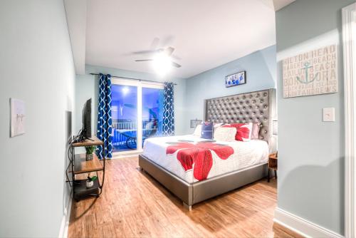 a bedroom with a bed with red pillows on it at Laketown Wharf Resort 631 By Aneliya in Panama City Beach