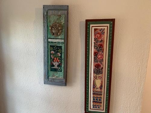 two pieces of art hanging on a wall at Pelion 7 Lives in Tsagarada