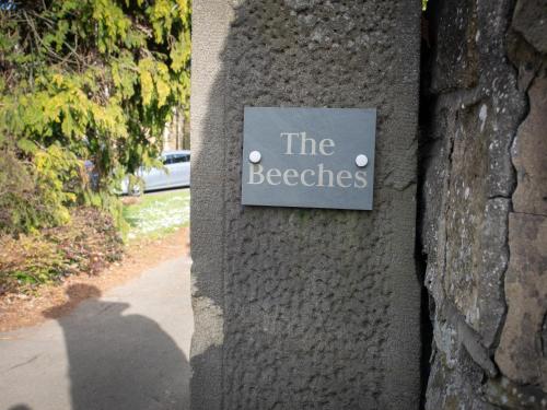 a sign on a wall that reads the beeches at The Beeches - Chatsworth Apartment No 5 - Sleeps 4 in Baslow