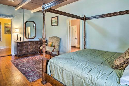 a bedroom with a bed and a mirror and a chair at Vintage Louisiana Vacation Rental Home in New Roads