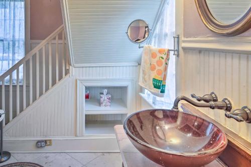 a bathroom with a bowl sink and a staircase at Vintage Louisiana Vacation Rental Home in New Roads