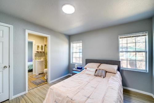 a bedroom with a large bed and two windows at Convenient Tulsa Home - 2 Mi to Downtown! in Tulsa