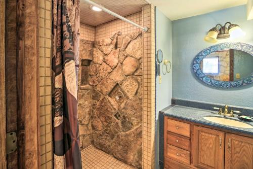 a bathroom with a shower with a wolf tile wall at Scenic Cottage with Views, 17 mi to San Antonio! in San Antonio