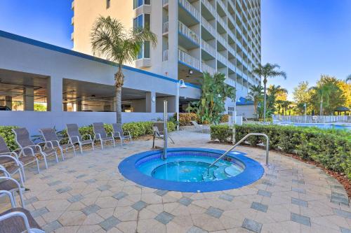 a hot tub in a patio with chairs and a building at Family Resort Condo with 2 Pools 1 Mi to Disney! in Orlando