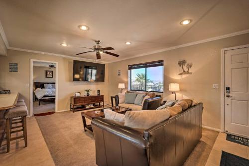 a living room with a couch and a table at 2 Mi to Lake Home with Fire Pit in Arizona! in Lake Havasu City