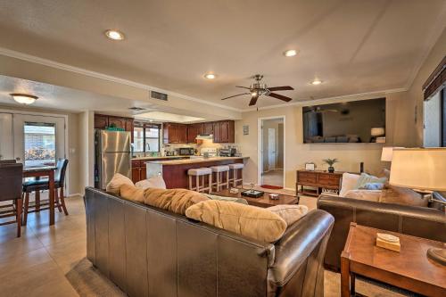 a living room with couches and a kitchen at 2 Mi to Lake Home with Fire Pit in Arizona! in Lake Havasu City