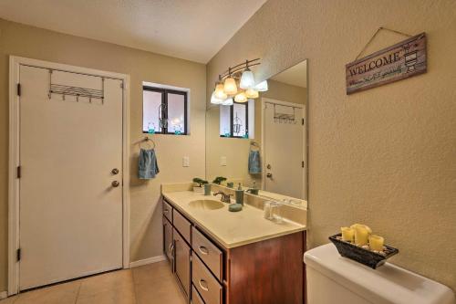 a bathroom with a sink and a mirror at 2 Mi to Lake Home with Fire Pit in Arizona! in Lake Havasu City