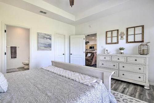 a bedroom with a bed and a dresser and a mirror at Vacation Home Rental Near South Padre Island in Laguna Vista