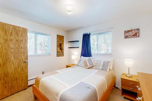 a bedroom with a large bed and two windows at The Sanctuary Bldg 5 #7-8 in Winter Park