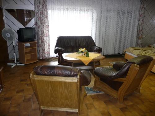 a living room with a table and chairs and a couch at Central Hotel in Schwetzingen