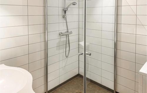 a shower with a glass door in a bathroom at Pet Friendly Apartment In Mesnali With Kitchen in Mesnali