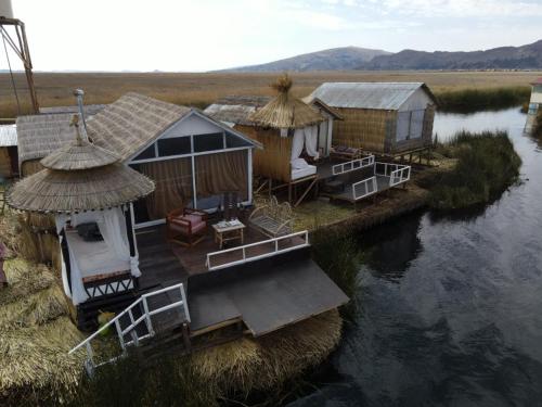 an aerial view of some huts on a river at Uros Lake Titicaca Lodge in Puno