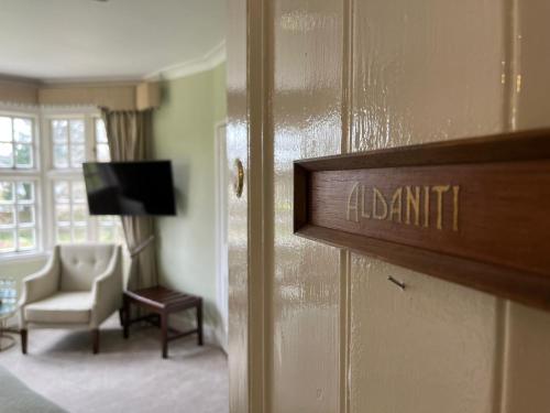 a door to a room with a living room at Findon Manor Hotel in Worthing