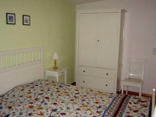 a bedroom with a bed and a dresser and a night stand at Ferienwohnung Albert in Kirchzell