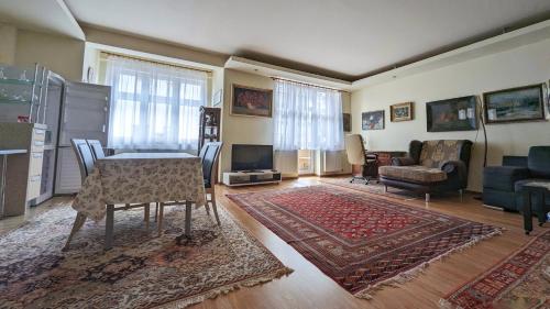 a living room with a table and chairs and a couch at Kamil Apartments, Lux S, 131m2 in Karlovy Vary