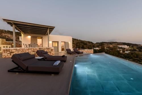 a villa with a swimming pool and a house at Villa Sunset in Aliki