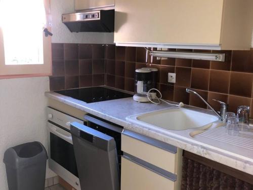 une cuisine avec un évier et un plan de travail dans l'établissement Charmant pavillon T2 avec terrasse et parking privé, près commerces et plage privée au Barcarès - FR-1-81-259, au Barcarès