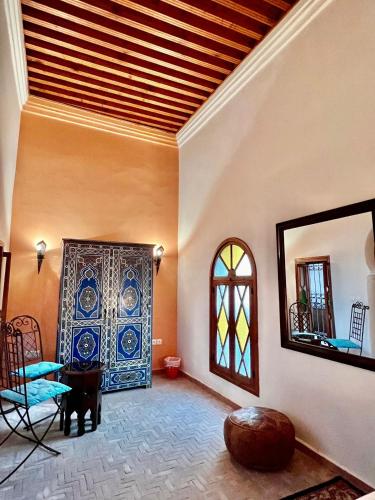 a living room with a stained glass door and a mirror at Riad Dar Hanae in Tetouan
