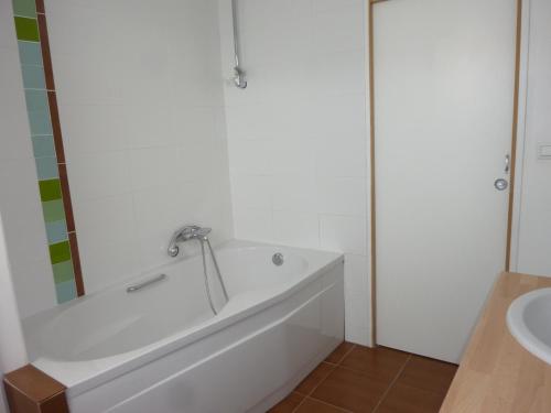a bathroom with a bath tub and a sink at Le Petite des Bouchots in Les Boucholeurs