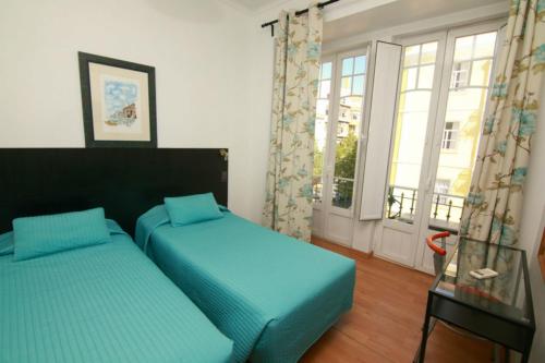 Postel nebo postele na pokoji v ubytování Residencial Joao XXI