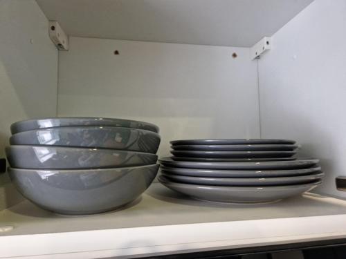 two bowls and plates are sitting on a shelf at 17 Queensgate in Inverness