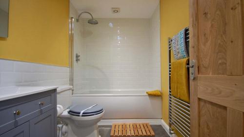 a bathroom with a white toilet and a shower at Earnbank in Lochearnhead