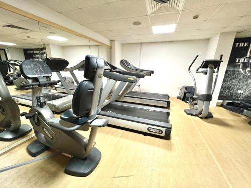 a gym with several tread machines in a room at Anmaria Beach Hotel & Spa in Ayia Napa