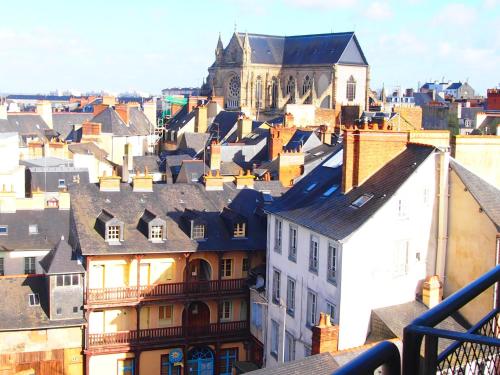 a view of a city with a church and buildings at Hotel Des Lices in Rennes
