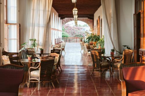 a restaurant with tables and chairs in a hallway at Casa Hacienda San Jose in Chincha Alta