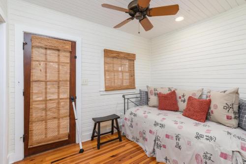 a bedroom with a bed and a ceiling fan at Longboard House in Tybee Island