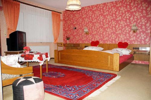 a bedroom with two beds and a table in it at Bayerischer Hof in Amorbach