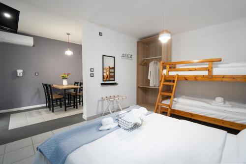 a bedroom with two bunk beds and a table at Camping Stolos in Limín Litochórou