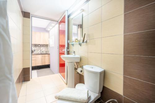 a bathroom with a toilet and a sink at Camping Stolos in Limín Litochórou