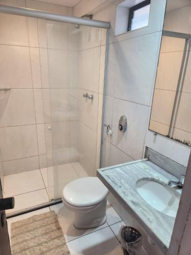 a bathroom with a shower and a toilet and a sink at Tabajara flats in Fortaleza