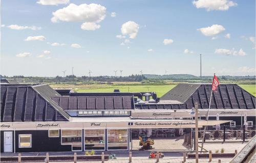 a train station with a building and a flag at One-Bedroom Apartment In Ringkobing in Ringkøbing