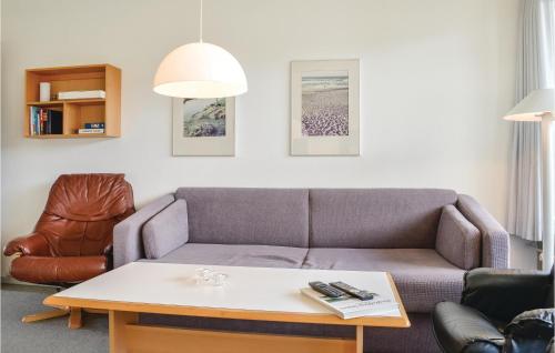 a living room with a couch and a coffee table at One-Bedroom Apartment In Ringkobing in Ringkøbing
