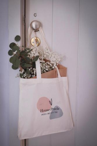 a tote bag with flowers and a plant at House Prada in Bragança